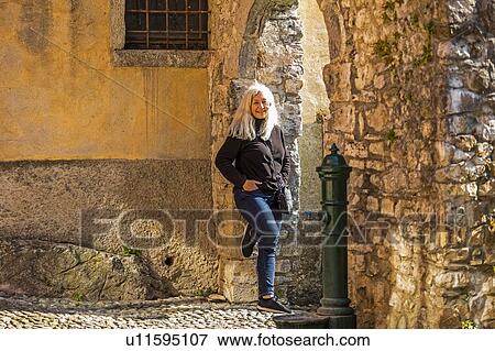 Mature woman leaning on stone arch in Lake Como, Italy View Large Photo Image Stock Photo - Mature woman leaning on stone arch in Lake Como, Italy. Fotosearch
