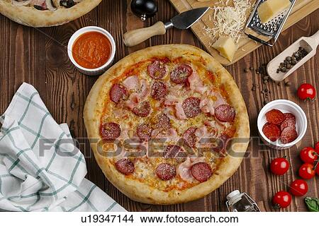 Picture - Meat pizza with ingredients. Fotosearch