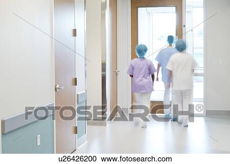 Medical staff walking down hospital corridor. View Large Photo Image Stock Image - Medical staff walking down hospital corridor.. Fotosearch