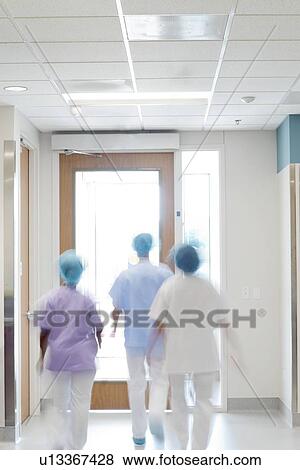 Medical staff walking down hospital corridor. View Large Photo Image Stock Photo - Medical staff walking down hospital corridor.. Fotosearch