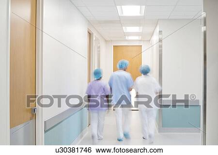 Medical staff walking down hospital corridor. View Large Photo Image Stock Photograph - Medical staff walking down hospital corridor.. Fotosearch