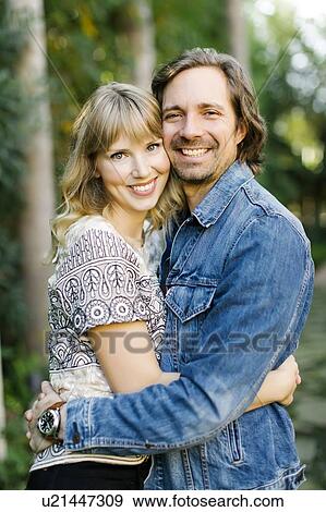 Stock Photo - Mid adult couple embracing. Fotosearch