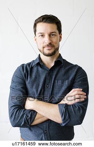 Mid adult man with his arms crossed View Large Photo Image Stock Photo - Mid adult man with his arms crossed. Fotosearch