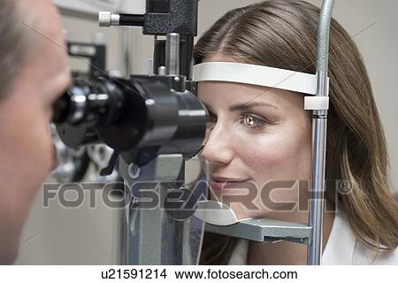 Mid adult woman having eye test. View Large Photo Image Picture - Mid adult woman having eye test.. Fotosearch