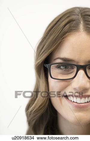 Mid adult woman wearing glasses, studio shot. View Large Photo Image Picture - Mid adult woman wearing glasses, studio shot.. Fotosearch