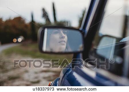 Mirror image of woman driving car View Large Photo Image Stock Image - Mirror image of woman driving car. Fotosearch