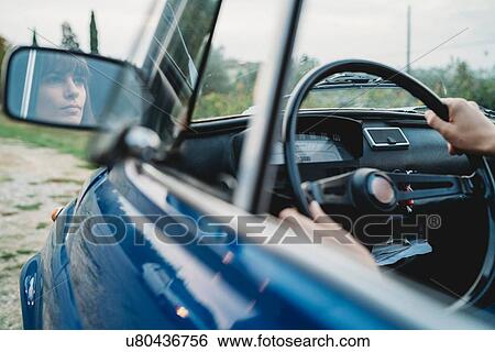 Mirror image of woman driving car View Large Photo Image Stock Photograph - Mirror image of woman driving car. Fotosearch