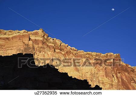 Moon over cliff in shadow in Capitol Reef National Park, USA View Large Photo Image Stock Photography - Moon over cliff in shadow in Capitol Reef National Park, USA. Fotosearch