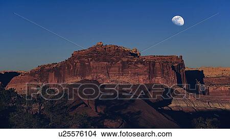 Picture - Moon over rock formation in Capitol Reef National Park, USA. Fotosearch