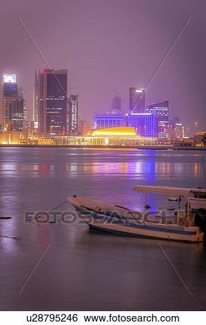 Moored motorboat by city skyline at night in Manama, Bahrain View Large Photo Image Stock Photograph - Moored motorboat by city skyline at night in Manama, Bahrain. Fotosearch