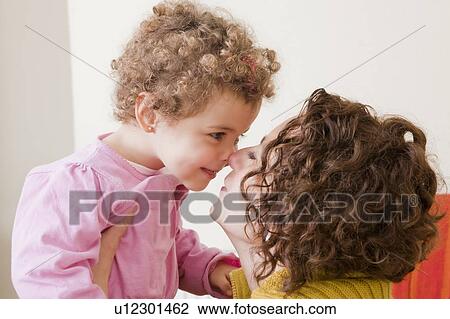 Stock Image - Mother and daughter face to face. Fotosearch