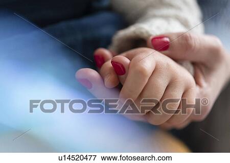 Stock Photo - Mother and daughter holding hands. Fotosearch