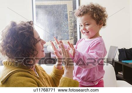 Mother and daughter playing clapping game View Large Photo Image Stock Image - Mother and daughter playing clapping game. Fotosearch