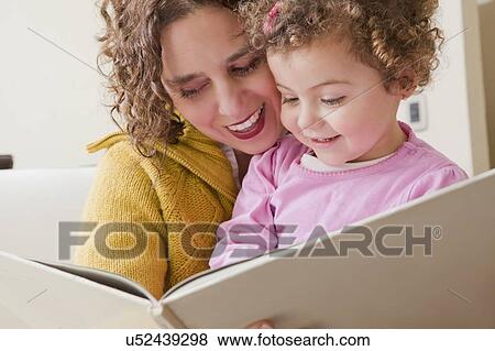Mother and daughter reading picture book View Large Photo Image Stock Photo - Mother and daughter reading picture book. Fotosearch
