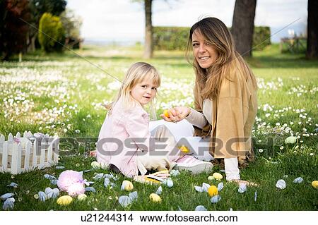 Mother and daughter relaxing in wildflower field after easter egg hunt, portrait, Arezzo, Tuscany, Italy View Large Photo Image Picture - Mother and daughter relaxing in wildflower field after easter egg hunt, portrait, Arezzo, Tuscany, Italy. Fotosearch