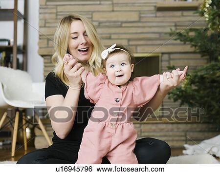 Mother holding her daughter's hands View Large Photo Image Stock Photograph - Mother holding her daughter's hands. Fotosearch