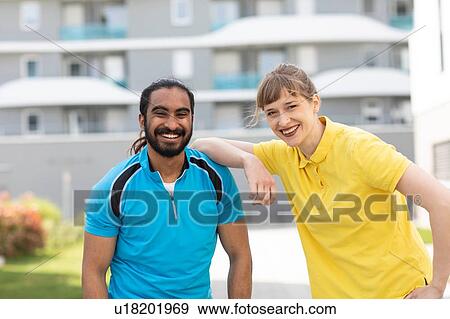 Stock Photo - Multi-ethnic couple taking break after exercise. Fotosearch
