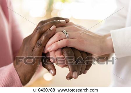 Stock Photo - Nurse holding hands of patient. Fotosearch