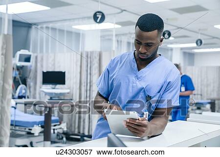 Stock Photo - Nurse using digital tablet in hospital. Fotosearch