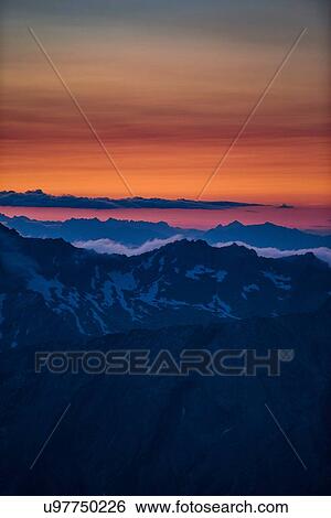 Orange glow on horizon over mountain range, Saas-Fee, Valais, Switzerland View Large Photo Image Stock Photograph - Orange glow on horizon over mountain range, Saas-Fee, Valais, Switzerland. Fotosearch