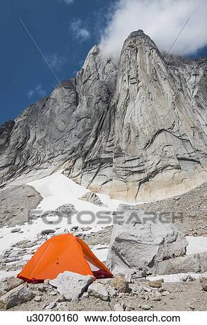 Stock Image - Orange tent in Purcell Mountains, Bugaboo Provincial Park, British Columbia, Canada. Fotosearch
