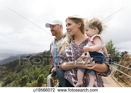 Parents with baby girl on mountain walkway View Large Photo Image Stock Image - Parents with baby girl on mountain walkway. Fotosearch