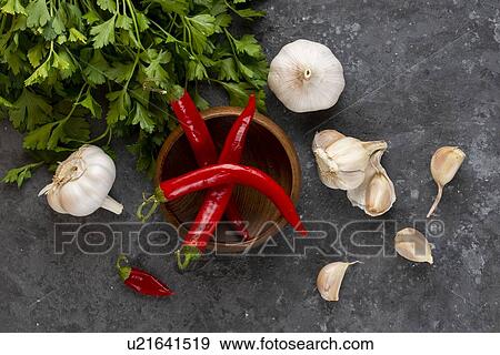 Stock Photo - Parsley, garlic and chili peppers. Fotosearch