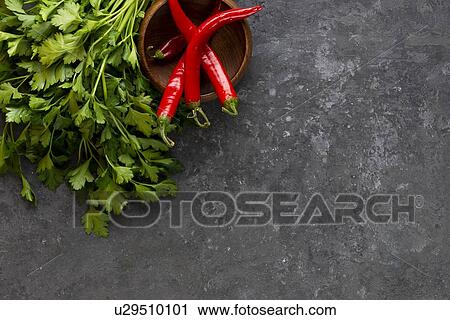 Parsley with chili peppers in bowl View Large Photo Image Stock Image - Parsley with chili peppers in bowl. Fotosearch