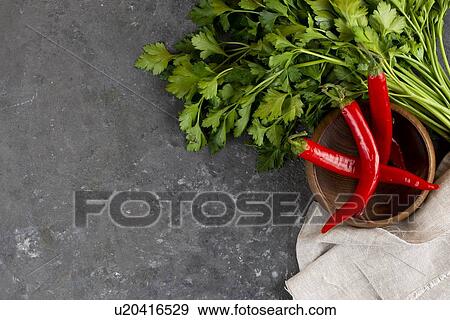 Parsley with chili peppers in bowl View Large Photo Image Stock Photo - Parsley with chili peppers in bowl. Fotosearch