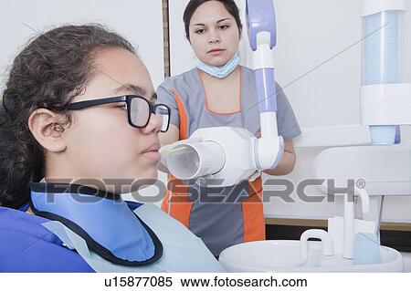Stock Photography - Patient getting X-ray at dentist's surgery. Fotosearch