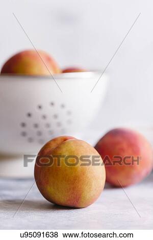 Stock Photo - Peaches with colander. Fotosearch