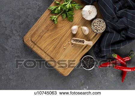 Pepper, garlic and parsley on cutting board by chili peppers View Large Photo Image Stock Image - Pepper, garlic and parsley on cutting board by chili peppers. Fotosearch
