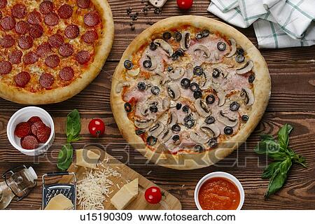 Pepperoni and mushroom pizzas with ingredients View Large Photo Image Stock Photo - Pepperoni and mushroom pizzas with ingredients. Fotosearch