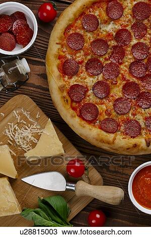 Stock Image - Pepperoni pizza with ingredients. Fotosearch