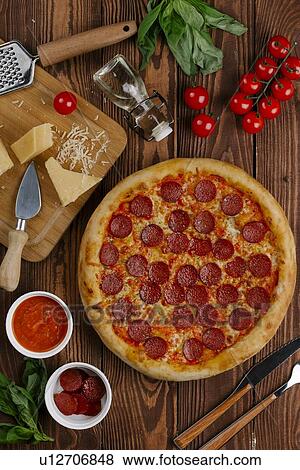 Stock Photo - Pepperoni pizza with ingredients. Fotosearch