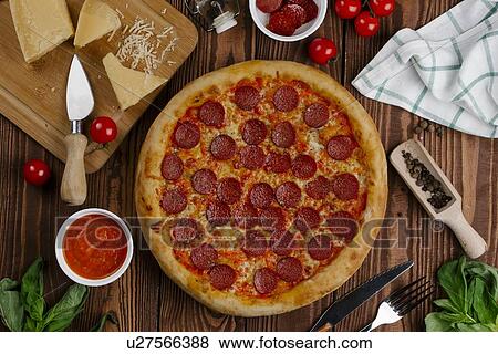 Stock Photo - Pepperoni pizza with ingredients. Fotosearch