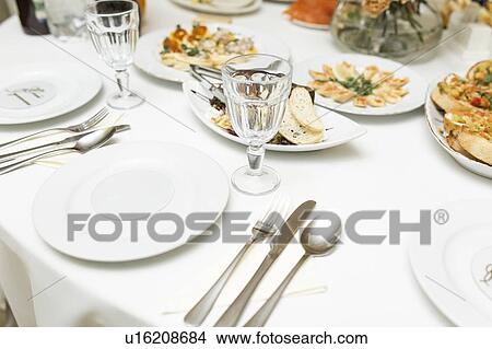 Picture - Place setting with appetizers. Fotosearch