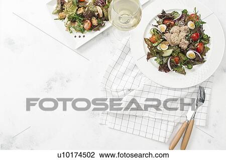 Stock Image - Plate of salad with white wine. Fotosearch