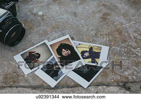Picture - Polaroid photographs of young woman by camera. Fotosearch