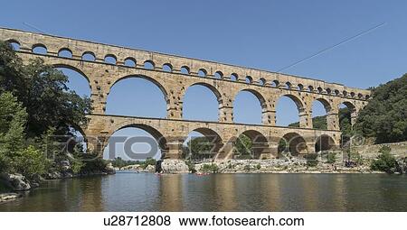 Stock Photo - Pont du Gard over Gardon River in Vers-Pont-du-Gard, France. Fotosearch