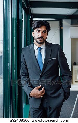Stock Photograph - Portrait of businessman in office. Fotosearch