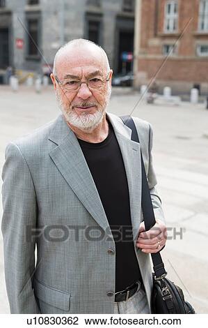Stock Image - Portrait of businessman in square, Milan, Lombardia, Italy. Fotosearch