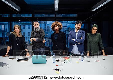 Stock Image - Portrait of confident business partners in office. Fotosearch