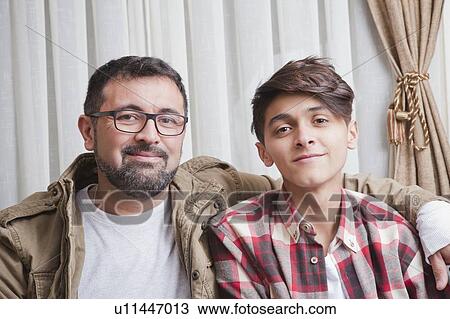 Stock Image - Portrait of father and teenage son. Fotosearch