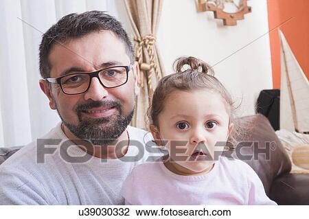 Stock Image - Portrait of man and his daughter. Fotosearch