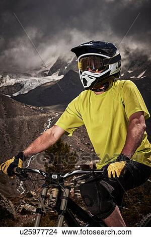 Picture - Portrait of mountain biker wearing helmet, Saas-Fee, Valais, Switzerland. Fotosearch
