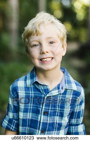 Stock Image - Portrait of smiling boy wearing checked shirt. Fotosearch