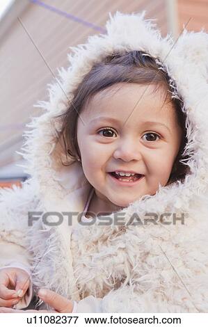 Portrait of smiling girl wearing white fur hood View Large Photo Image Stock Photo - Portrait of smiling girl wearing white fur hood. Fotosearch