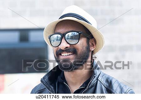 Portrait of smiling man with hat and sunglasses View Large Photo Image Stock Photography - Portrait of smiling man with hat and sunglasses. Fotosearch