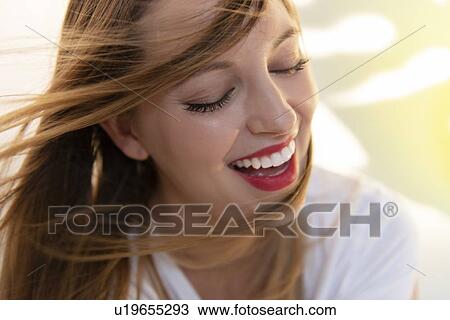 Portrait of windswept young woman wearing red lipstick View Large Photo Image Stock Image - Portrait of windswept young woman wearing red lipstick. Fotosearch